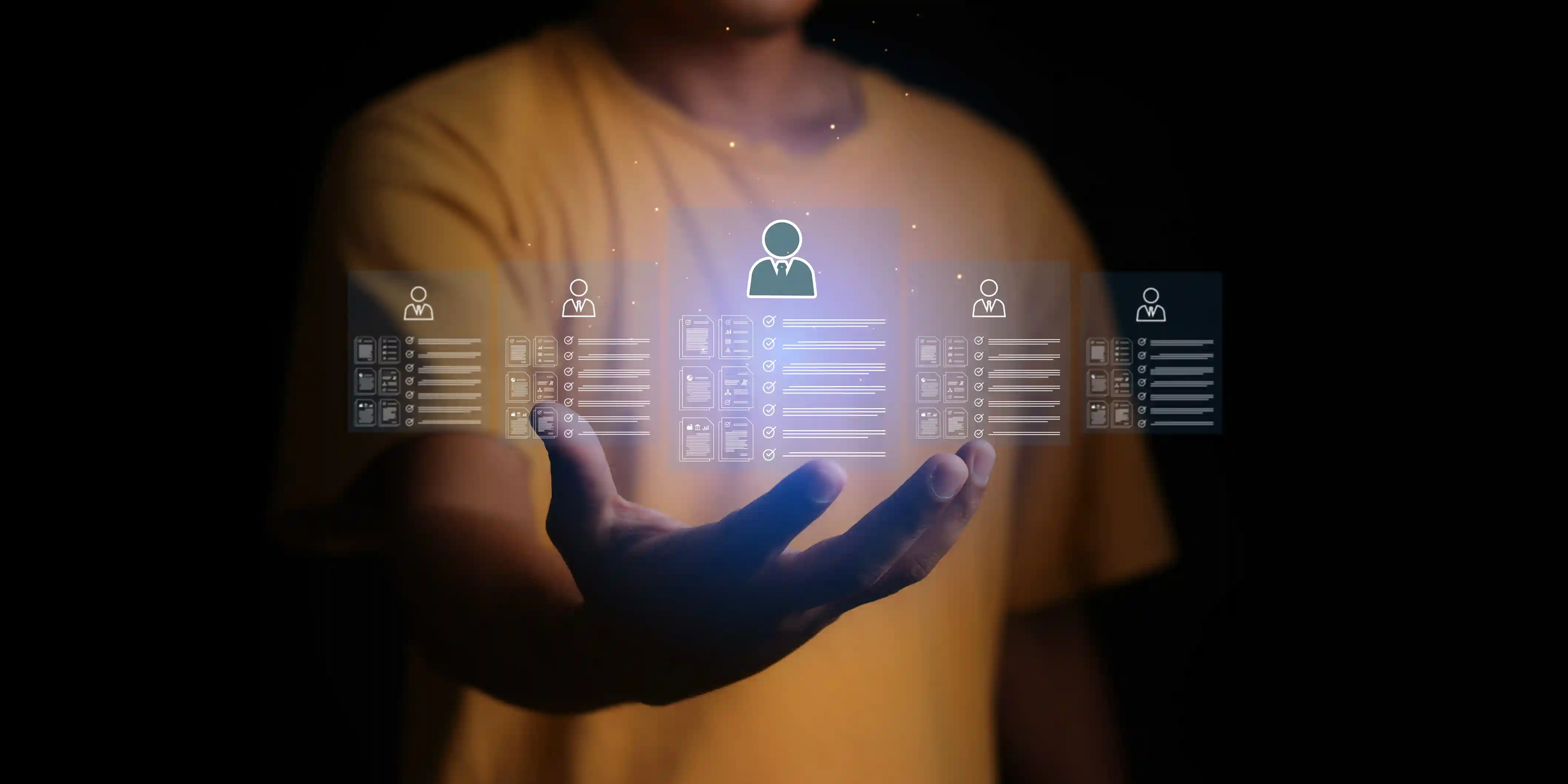 A person in a yellow shirt holds a glowing virtual panel with user profiles in the dark. Central icon highlighted, tech-oriented mood.